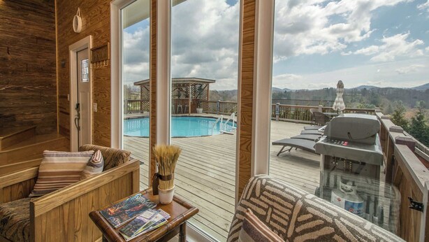 A wooden deck with a pool, lounge chairs, and a barbecue grill. - Poolside ADU w Sauna  Free Tix  Tiki Bar Retreat (Candler)