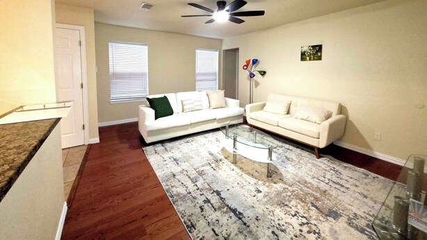 A living room with a white sofa, a glass coffee table, and a ceiling fan. - Spacious 3BR Near AT&T Stadium-Global Life Field-Texas Live!-FIFA WorldCup2026 (Arlington)