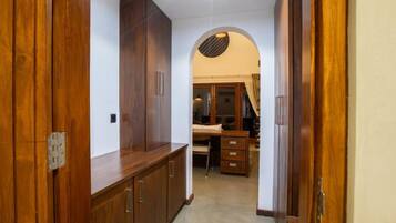 A hallway with wooden cabinets and a desk area.