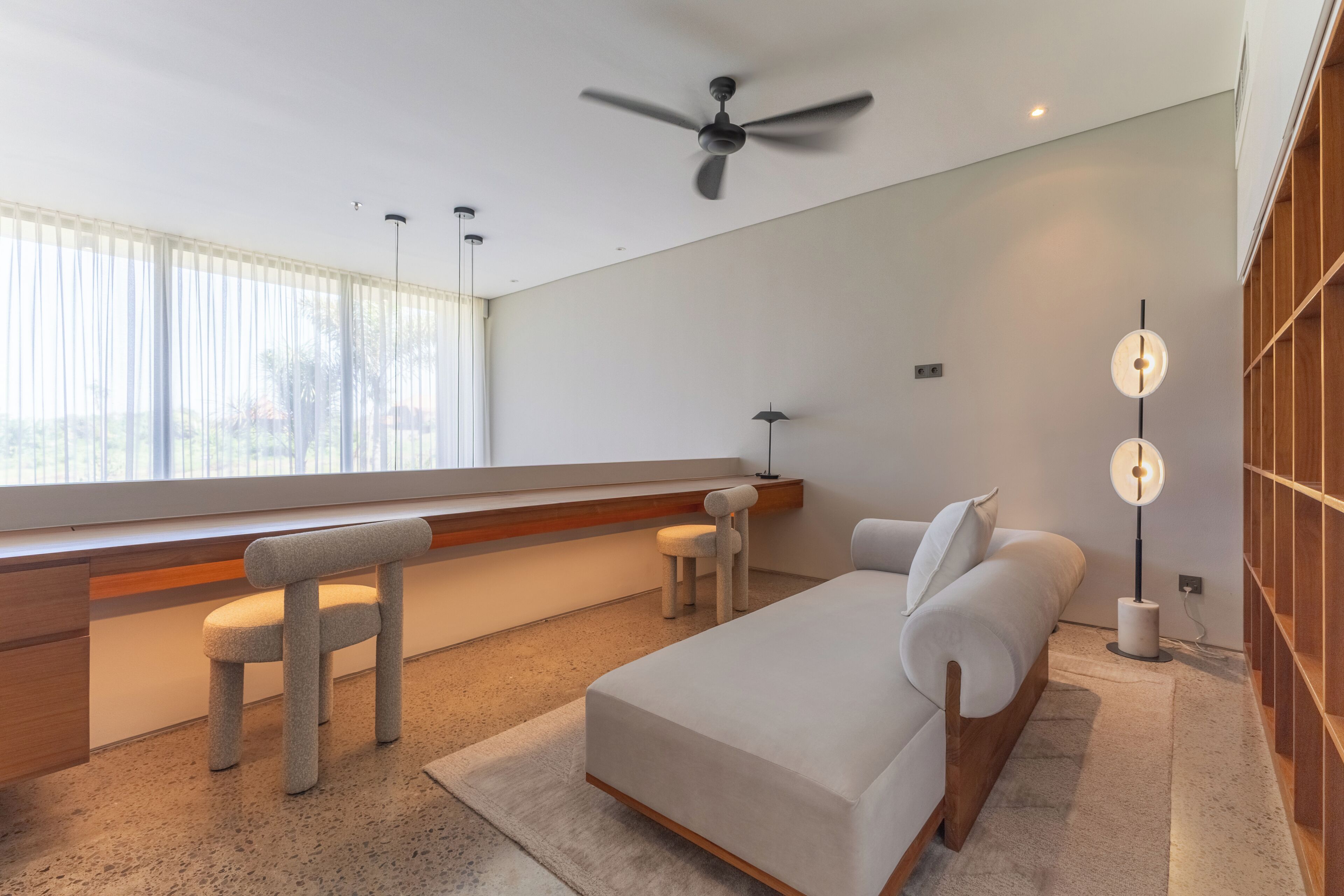 A modern bedroom with a bed, a desk, and a chair.