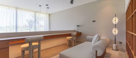 A modern bedroom with a bed, a desk, and a chair.