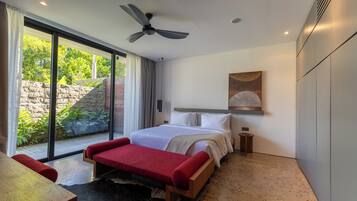 Quarto moderno com cama grande, ventoinha no teto, mesinha de cabeceira e vista para o exterior.