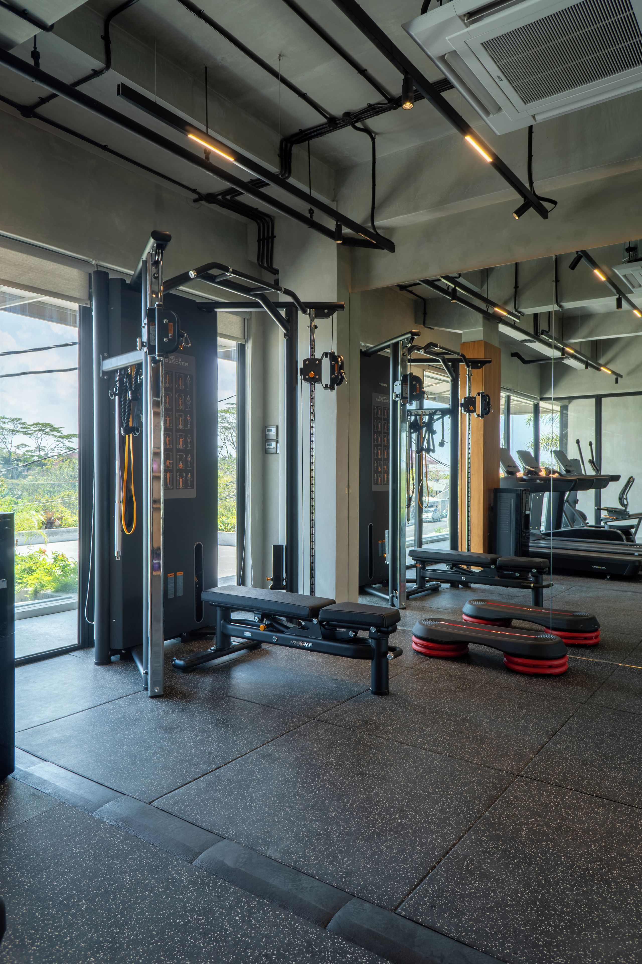 A gym with various exercise equipment, including weight machines and treadmills.