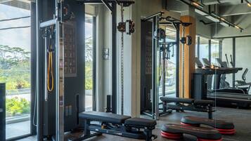 A gym with various exercise equipment, including weight machines and treadmills.