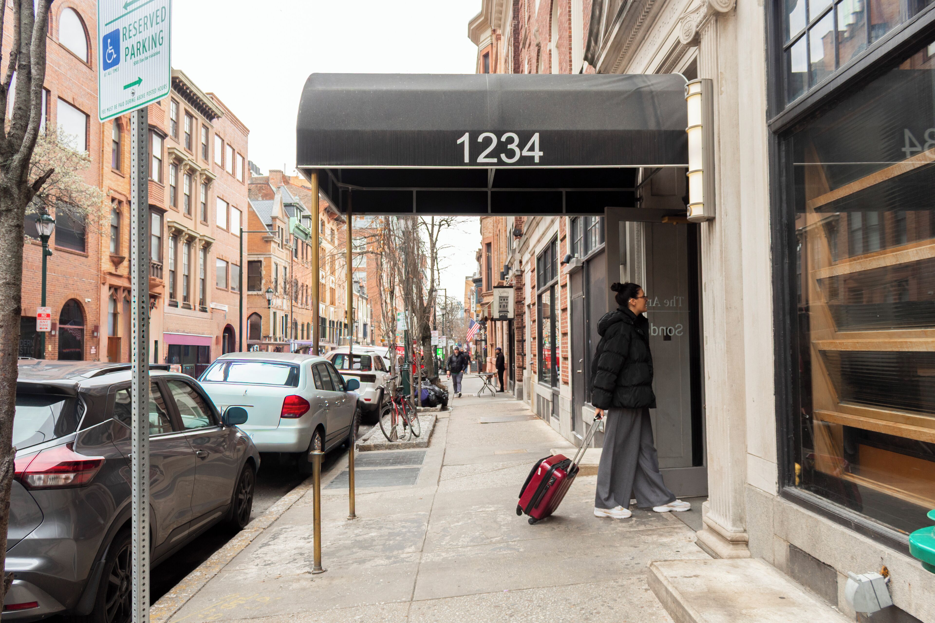 A building with a black awning displaying the number 1234.