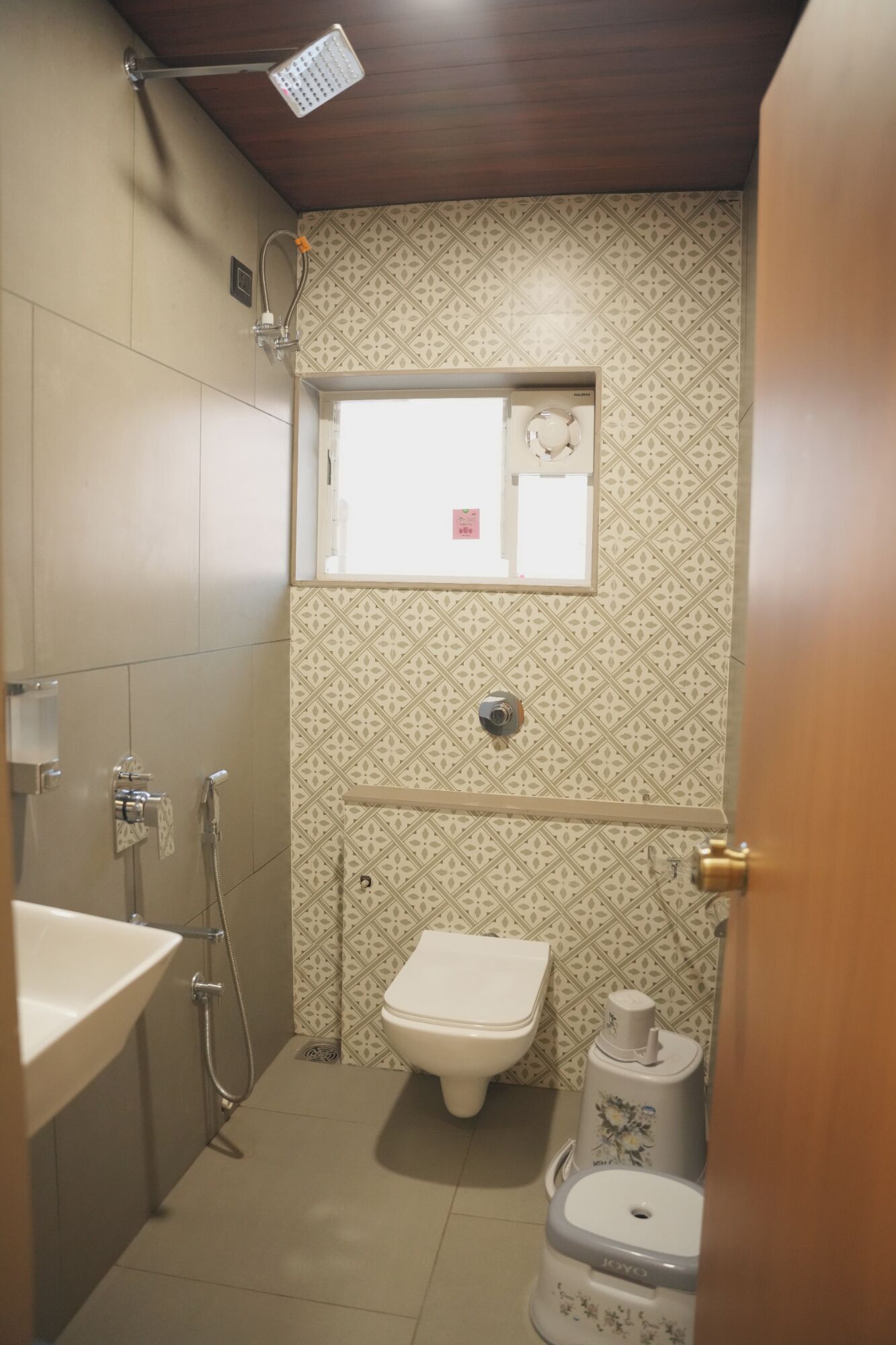 A small bathroom with a toilet, bidet, and shower.