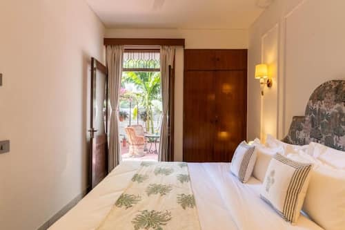 Deluxe Double Room, Patio, Garden View | In-room safe, desk, laptop workspace, blackout curtains