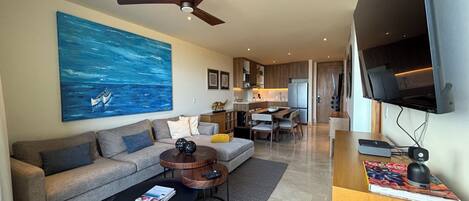 A modern living room with a sofa, coffee table, and artwork.