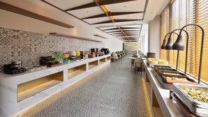 A long buffet line with various food stations, a patterned wall, and a ceiling with wooden beams and recessed lighting. - Nostalgia Hotel Hangzhou Wulinmen Branch (Hangzhou)
