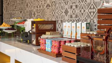 A buffet area with various food items and beverages.