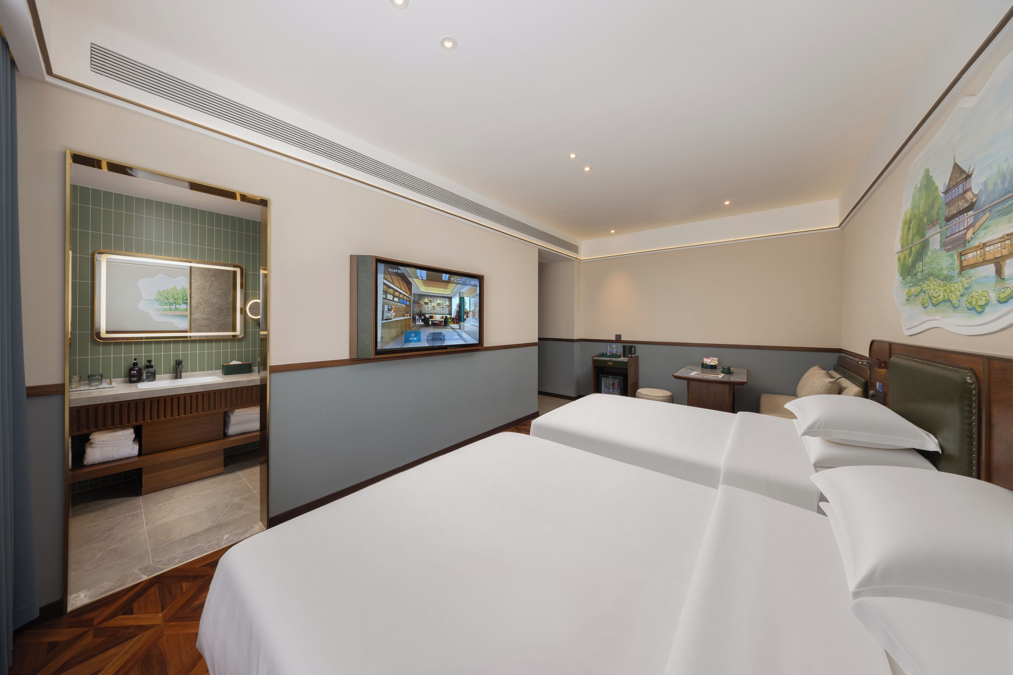 Una habitación de hotel con una cama grande, un baño con tocador, un televisor y un cuadro en la pared.