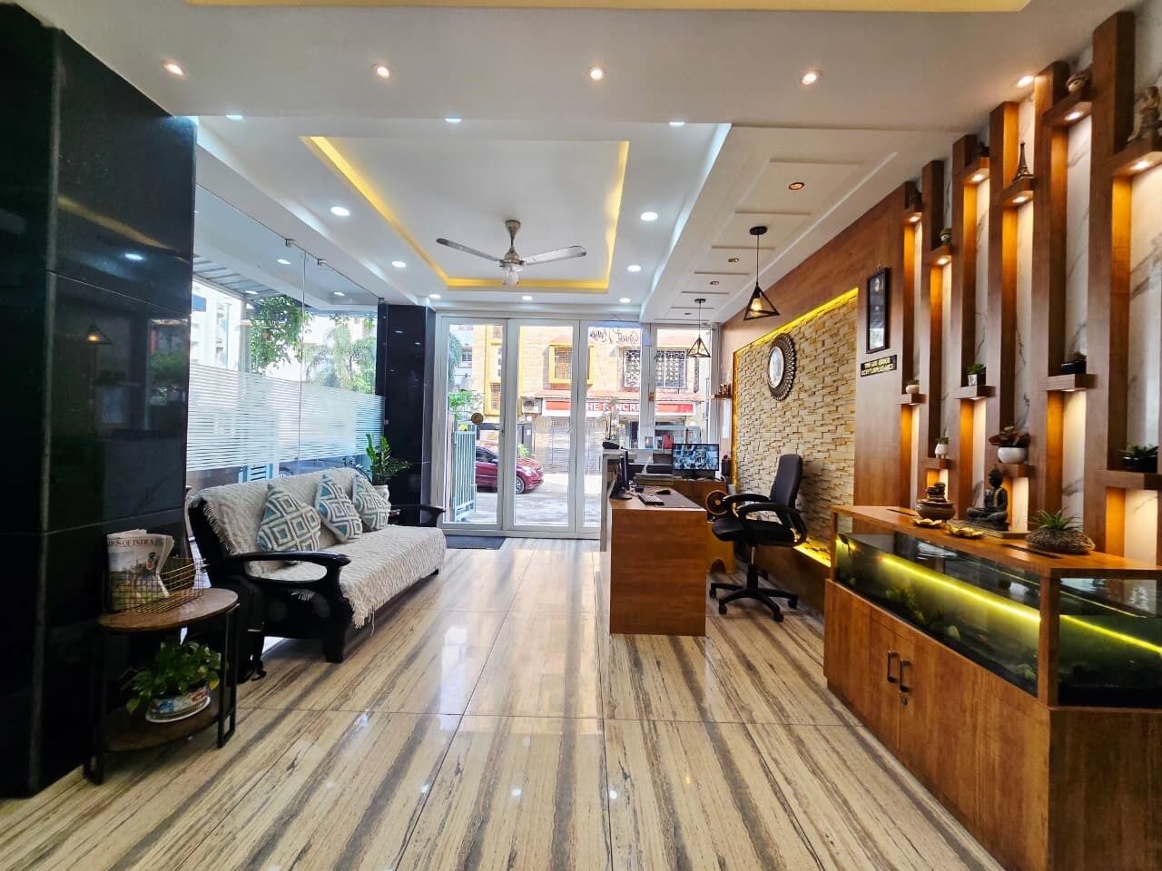 A reception area with a wooden desk, a sofa, and a coffee table.