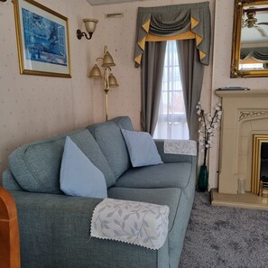 Living area - 2-bed modern caravan with patio doors onto full veranda (Burgh le Marsh)