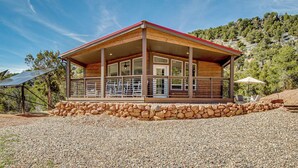A modern building with a stone foundation, large windows, and a red roof. - Canyon Escape Near Dixie Nat’l Forest & ATV Trails (Paragonah)