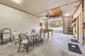A room with a foosball table, chairs, and a table with a board game. - Near Pine Knob, Lakes & Trails! Ortonville Getaway (Ortonville)