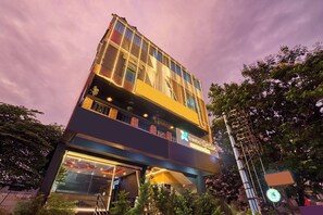 A multi-story building with a prominent sign for 'treebo' and a visible staircase leading to the entrance. - Treebo Three Street Inn RR Nagar (Bangalore)