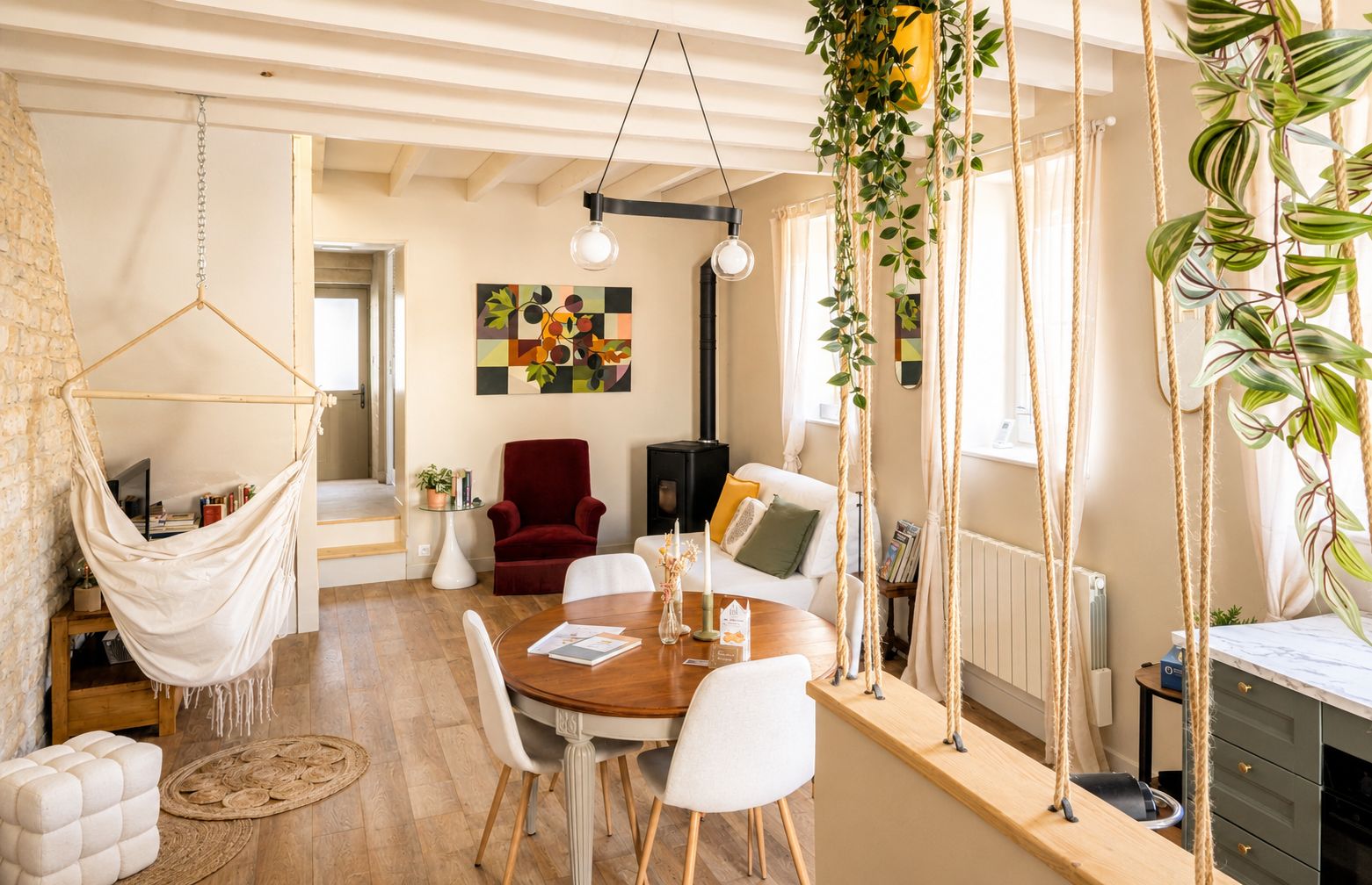 A cozy living room with a hammock, a red chair, a dining table with chairs, and a hanging plant.