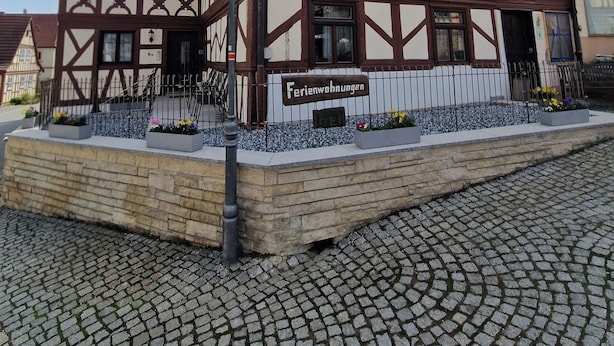 A traditional half-timbered building with a sign reading 'Ferienwohnungen' indicating it is a guesthouse. - Apartments Merkel (Rattelsdorf)