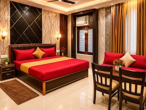 A hotel room with a large bed, bedside tables, a desk with chairs, a window with curtains, and an air conditioning unit. - V4Y Hotel 4U Tapovan Rishikesh (Rishikesh)