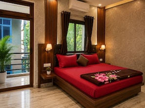 A modern hotel room with a large bed, two bedside lamps, a window with curtains, a potted plant, and an air conditioning unit.