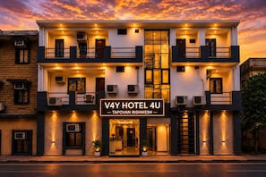 A modern hotel with a sign reading 'V4Y HOTEL 4U - TAPOVAN RISHIKESH.'