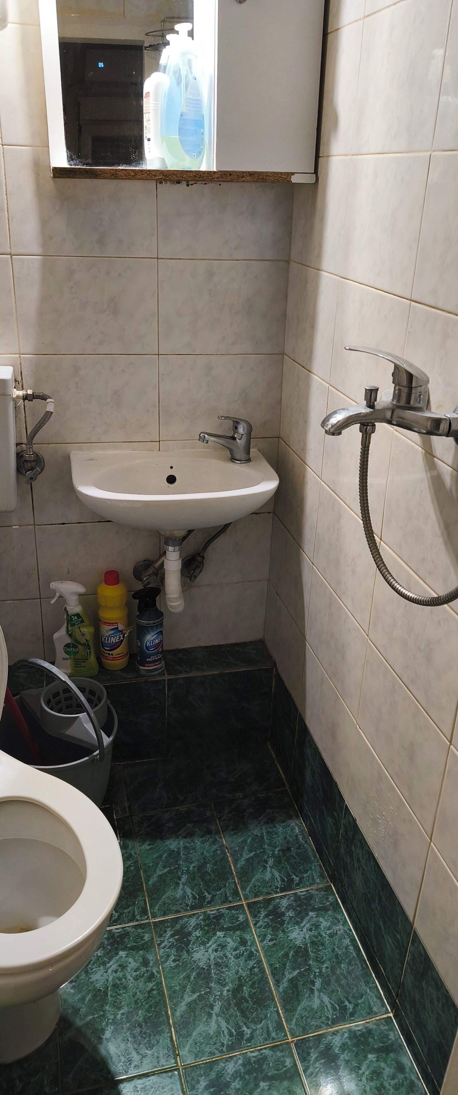 A bathroom with a sink, toilet, and shower.