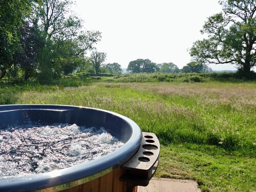 Large luxury shepherd's hut with hot tub in the stunning Welsh countryside.