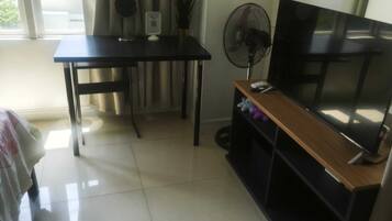 Comfort Studio, 1 Queen Bed with Sofa bed, Pool Access, City View | Living area | 43-inch Smart TV with cable channels, books