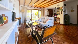 A spacious living area with a sofa, chairs, a coffee table, and a dining table. - La Caleta 'Mediterranean beachfront house' (Caleta de Vélez)