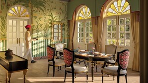 A dining room with a table set for four, surrounded by chairs with patterned upholstery. - Storii By ITC Hotels Jawai (Bali)