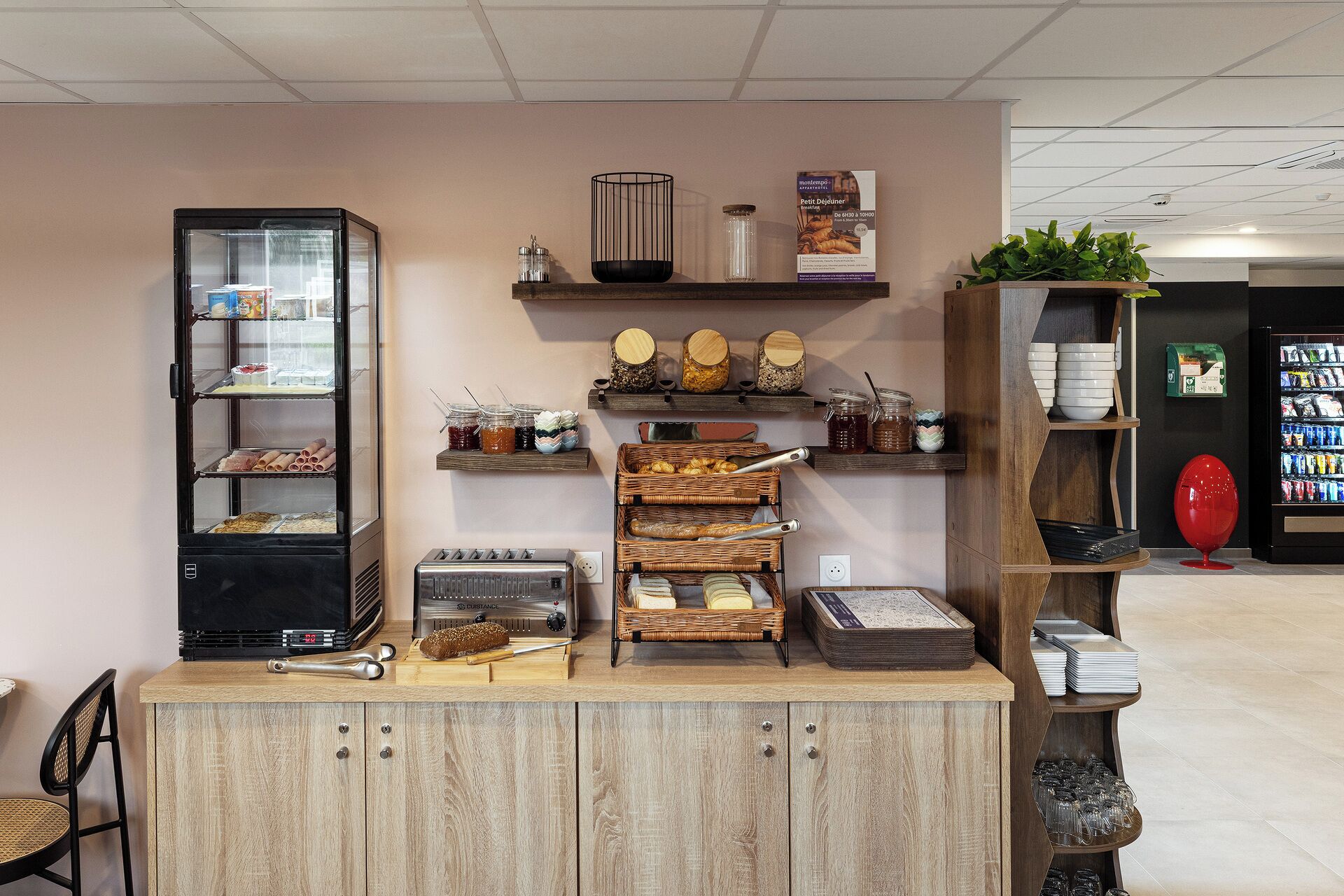 A bakery display with various baked goods, jars of spreads, and a coffee machine.