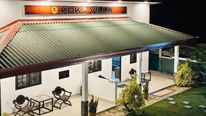 A building with a sign reading 'KOKO VILLA' and a covered outdoor seating area with tables and chairs. - KOKO Villa (Negombo)