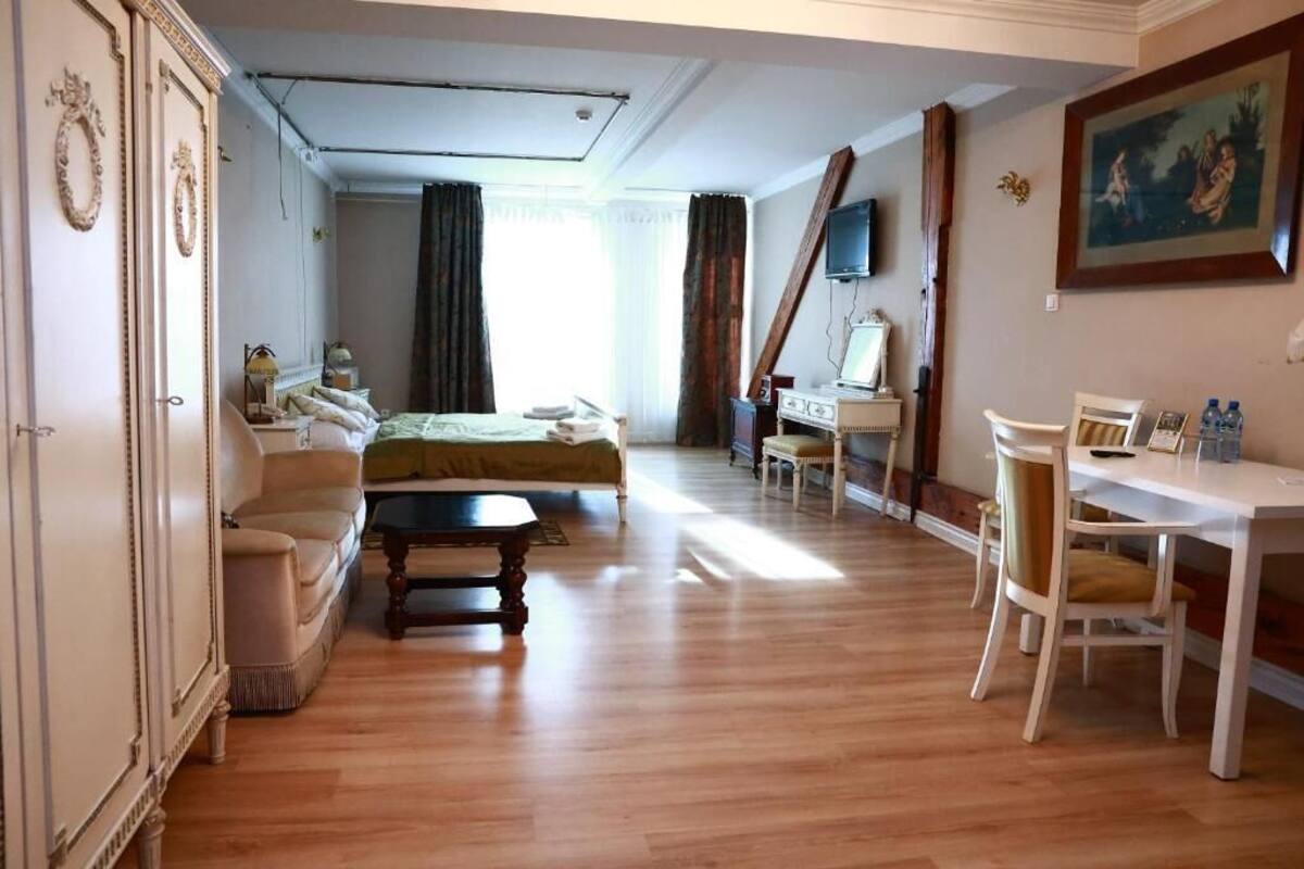 Una stanza con un letto, una scrivania, una sedia, un armadio e una televisione.