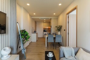 A modern apartment with a dining area, kitchen, and living room. - Bangtao Laguna Apartment 42 sq.m in picturesque Phuket. (Choeng Thale /Thalang)