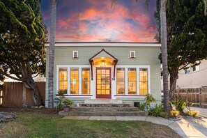 A two-story house with a front porch, a mailbox, and a well-maintained lawn. - Ocean Beach House 3BR, Parking, Large Patio, Firepit, Grill and 2 blocks from the beach (San Diego)