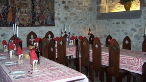 A long dining table with chairs, candles, and a vase with flowers. - demi-château de Paulignan for 15 people (TRAUSSE)