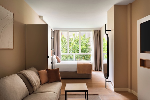 Studio with Sofa Bed | Living area | 50-inch flat-screen TV with cable channels