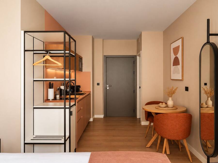 Un dormitorio moderno con cama, mesita de noche y un espejo grande.