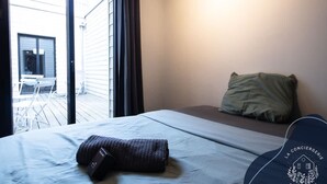 Hotellihuone, jossa on sänky, tyyny ja näkymä ulos.