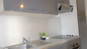 A kitchen with a sink, stove, oven, and cabinets. - Sublime 2 Bollaert 4 Pers Centre Ville (Lens)