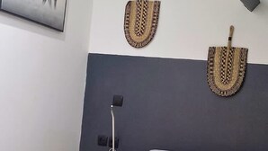 A bedroom with a bed, a wall-mounted picture, and two wall-mounted baskets. - Safari Lensois Wifi Proche Bollaert 3 Pers (Lens)