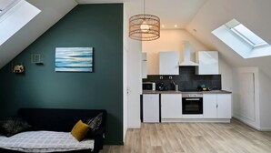 Een moderne loft met een keuken, een eethoek en een slaapgedeelte.