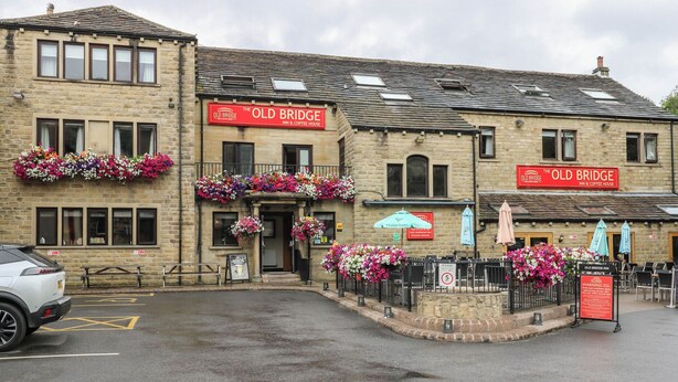 A two-story building with a sign reading 'The Old Bridge Inn & Coffee House.' - The Annex at Ryefield Lodge (Holmfirth)
