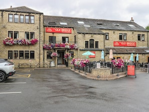 A two-story building with a sign reading 'The Old Bridge Inn & Coffee House.' - The Annex at Ryefield Lodge (Holmfirth)