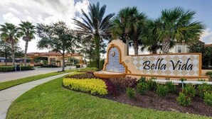 Une enseigne pour Bella Vida, agrémentée d’une arche décorative et d’un jardin bien entretenu.