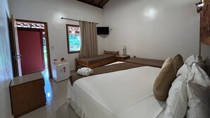 A bedroom with a bed, a small bedside table, a nightstand, a window with curtains, a wall-mounted TV, and a door. - Pousada Meraki (Santana do Riacho)