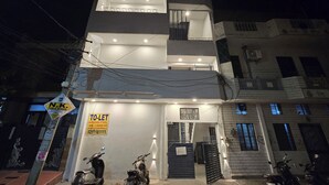 A multi-story building with a sign indicating a public school, a toilet, and a furnished studio. - Peaceful 1BHK 🌿 WiFi near by GT Mall, Airport” ✅ Jawahar circle malviya nagar (Jaipur)