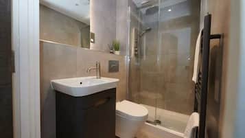 Shower, hair dryer, towels, shampoo