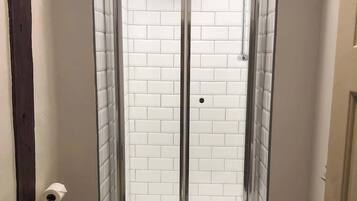 Shower, hair dryer, towels, shampoo