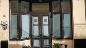 A hotel entrance with a glass door, a fire alarm, and a number '10' on the wall. - Piccolo Borgo (Chiavari)